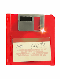 a red floppy disk with a note on it